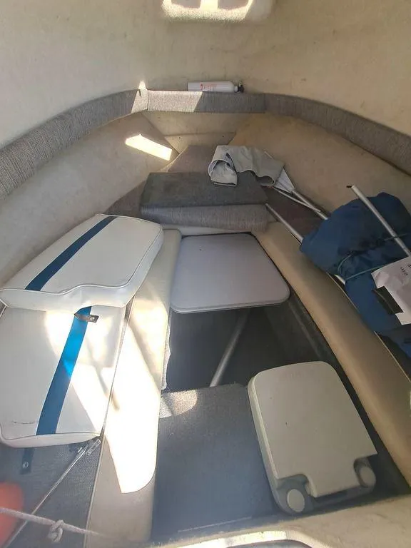 Slide: The Image of 1998 Bayliner 2052 cabin interior with seating and storage. - 1