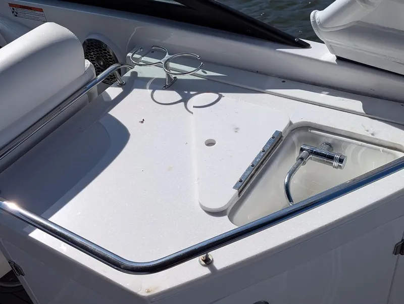 Slide: The Image of 2023 Monterey M-65 boat sink area with cup holders and faucet. - 12