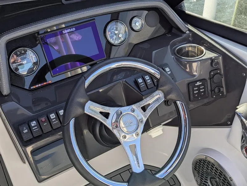 Slide: The Image of Cockpit of 2023 Monterey M-65 boat with steering wheel, gauges, and control panel. - 13