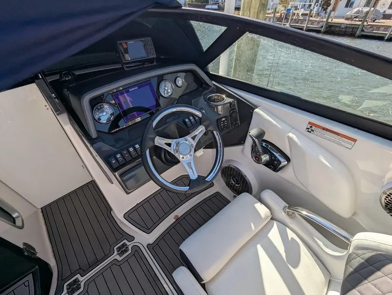 Slide: The Image of 2023 Monterey M-65 boat cockpit with modern controls and steering wheel. - 15