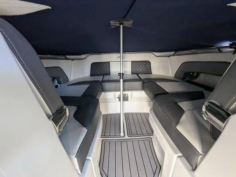 Slide: The Image of 2023 Monterey M-65 boat interior with cushioned seating and sleek design. - 19
