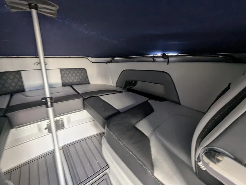 Slide: The Image of 2023 Monterey M-65 boat interior with cushioned seating and sleek design. - 20