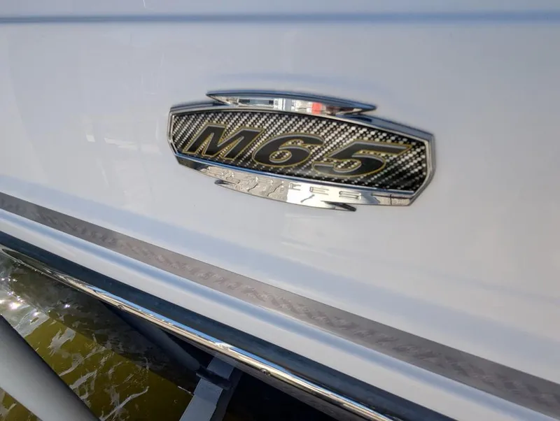 Slide: The Image of 2023 Monterey M-65 boat emblem on white exterior. - 22