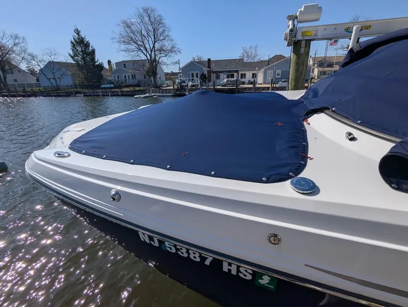 Slide: The Image of 2023 Monterey M-65 boat docked, covered with a blue tarp, in a residential waterfront area. - 24