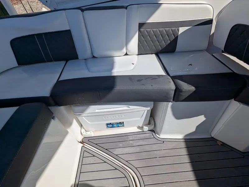 Slide: The Image of 2023 Monterey M-65 boat interior with cushioned seating and storage compartment. - 25
