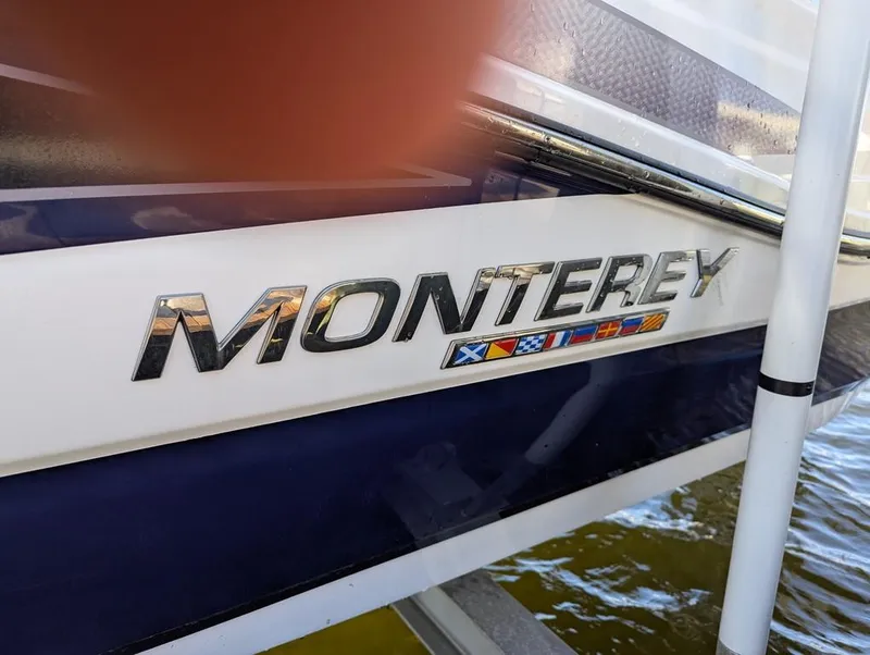 Slide: The Image of 2023 Monterey M-65 boat logo with nautical flags on the side. - 27