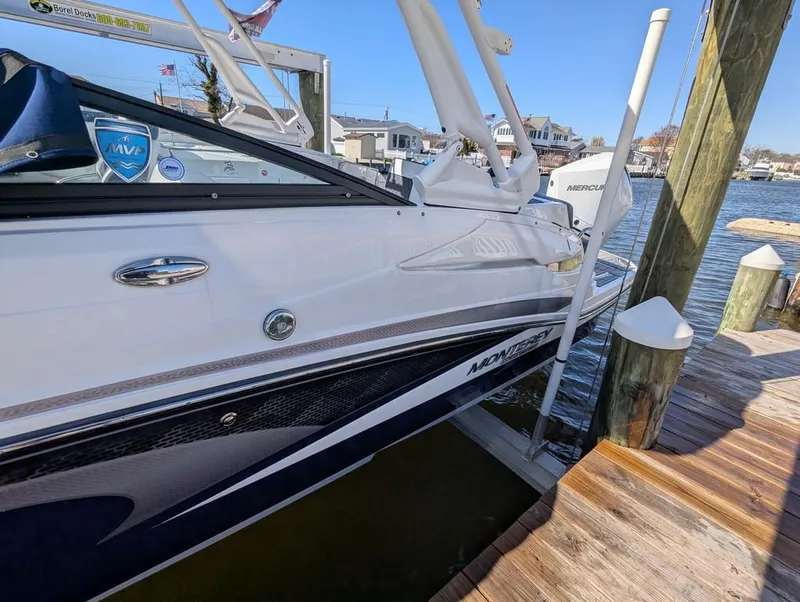 Slide: The Image of 2023 Monterey M-65 boat docked by waterfront, showcasing sleek design and modern features. - 28