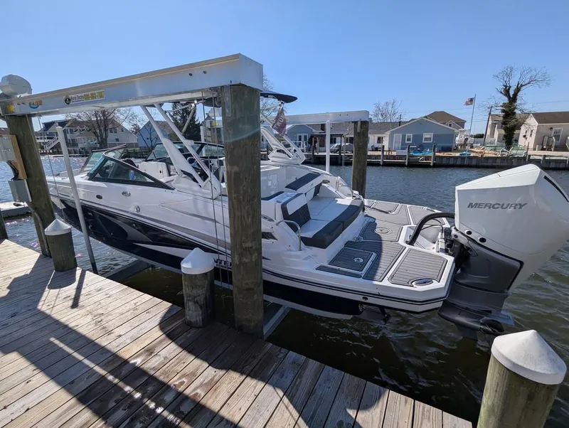 Slide: The Image of 2023 Monterey M-65 boat docked with Mercury engine, sunny day, waterfront homes in background. - 3