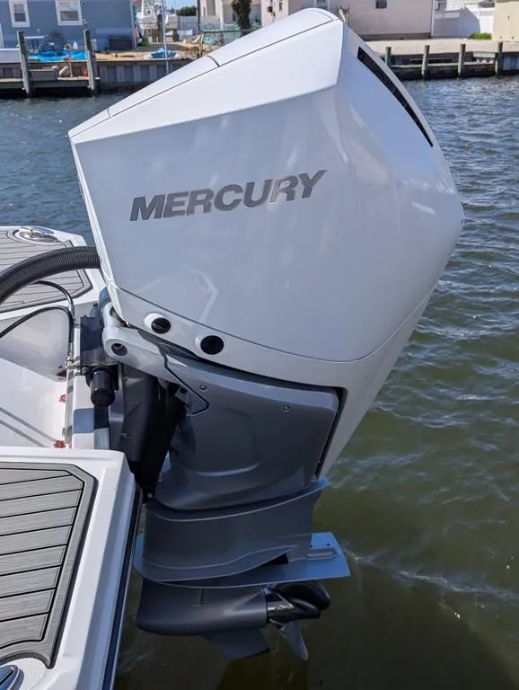 Slide: The Image of 2023 Monterey M-65 boat with a Mercury outboard motor on the water. - 37