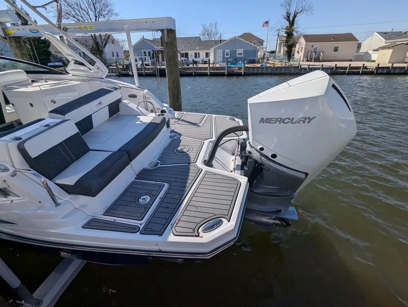 Slide: The Image of 2023 Monterey M-65 boat with Mercury outboard engine docked by waterfront homes. - 38
