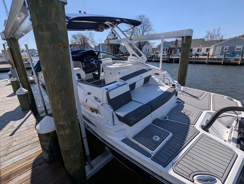 Slide: The Image of 2023 Monterey M-65 boat docked, featuring sleek design and spacious seating. - 39