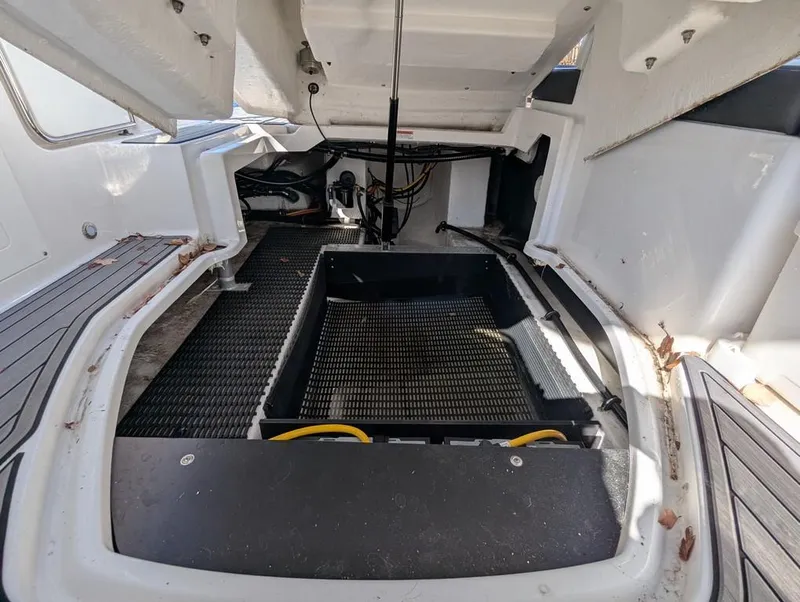 Slide: The Image of Open engine compartment of 2023 Monterey M-65 boat, showcasing interior components and storage space. - 40