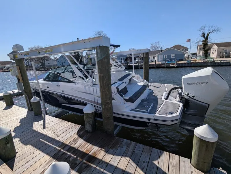 Slide: The Image of 2023 Monterey M-65 boat docked, featuring a sleek design and Mercury outboard engine. - 41