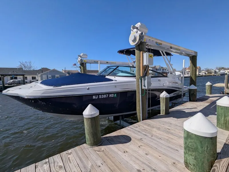 Slide: The Image of 2023 Monterey M-65 boat docked on a sunny day, showcasing sleek design and modern features. - 42