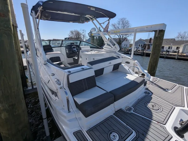 Slide: The Image of 2023 Monterey M-65 boat docked, featuring sleek seating and modern design. - 44