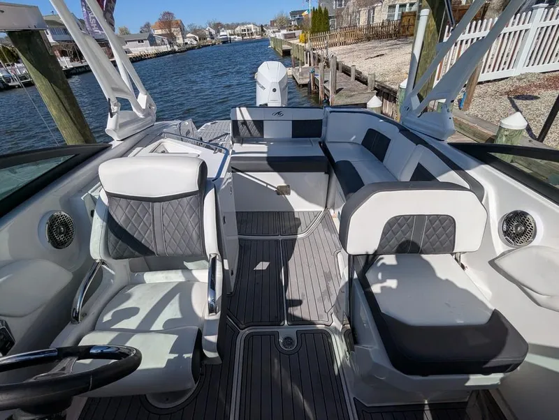 Slide: The Image of 2023 Monterey M-65 boat interior with sleek seating and waterfront view. - 47
