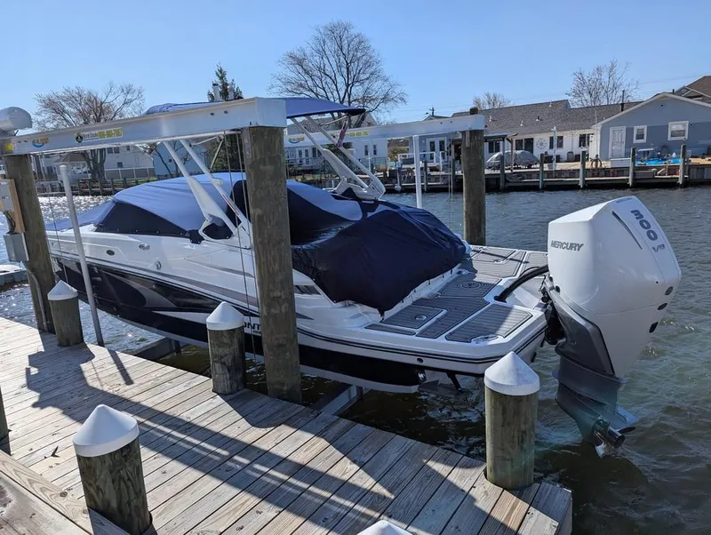 Slide: The Image of 2023 Monterey M-65 boat docked with Mercury outboard engine, covered and secured. - 7