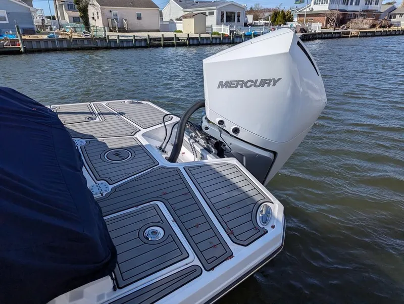 Slide: The Image of 2023 Monterey M-65 boat with Mercury outboard engine on a calm waterfront. - 8