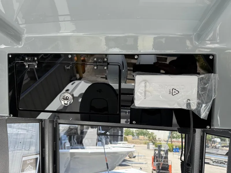 Slide: The Image of 2025 Sea Pro 262 Offshore boat dashboard with storage compartment and packaging. - 30