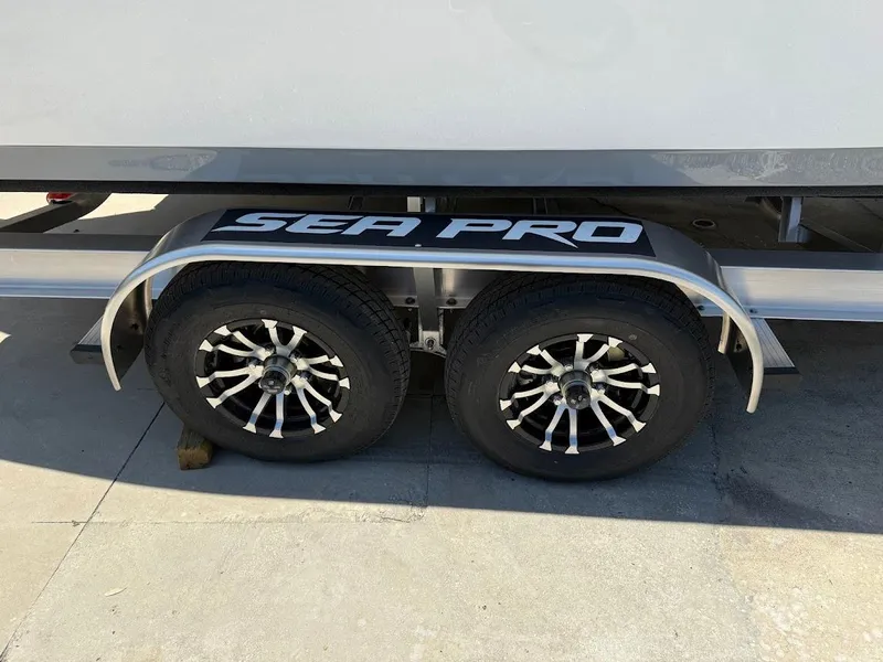 Slide: The Image of Trailer wheels of 2025 Sea Pro 262 Offshore boat on pavement. - 4