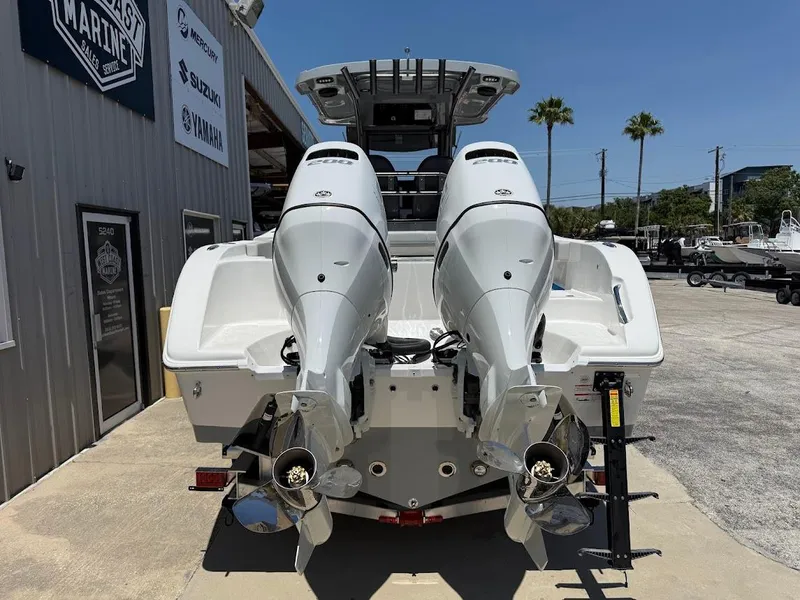 Slide: The Image of 2025 Sea Pro 262 Offshore boat with dual outboard engines, parked at a marina. - 7