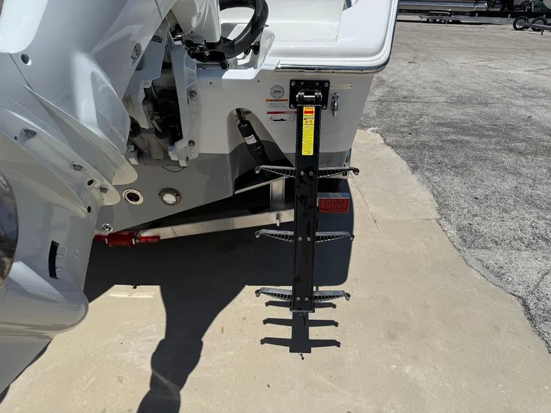 Slide: The Image of 2025 Sea Pro 262 Offshore boat stern with mounted ladder on a concrete surface. - 9