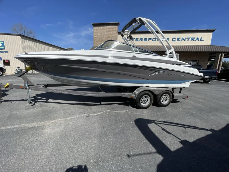 Slide: The Image of 2023 Crownline 240 SS boat on trailer outside Watersport Central dealership. - 1