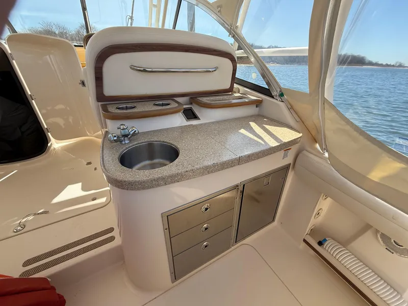 Slide: The Image of 2015 Grady-White Freedom 335 boat interior with kitchenette and storage drawers. - 14