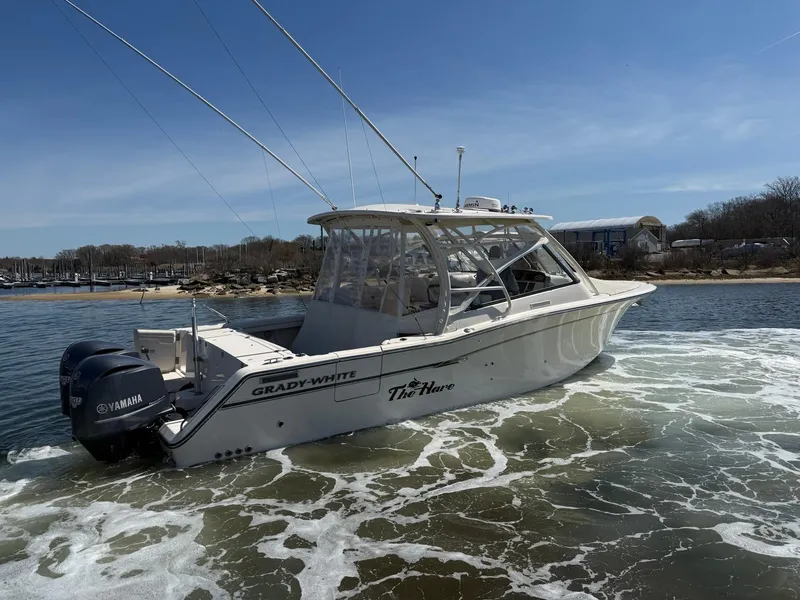 Slide: The Image of 2015 Grady-White Freedom 335 boat with twin Yamaha engines on the water. - 3