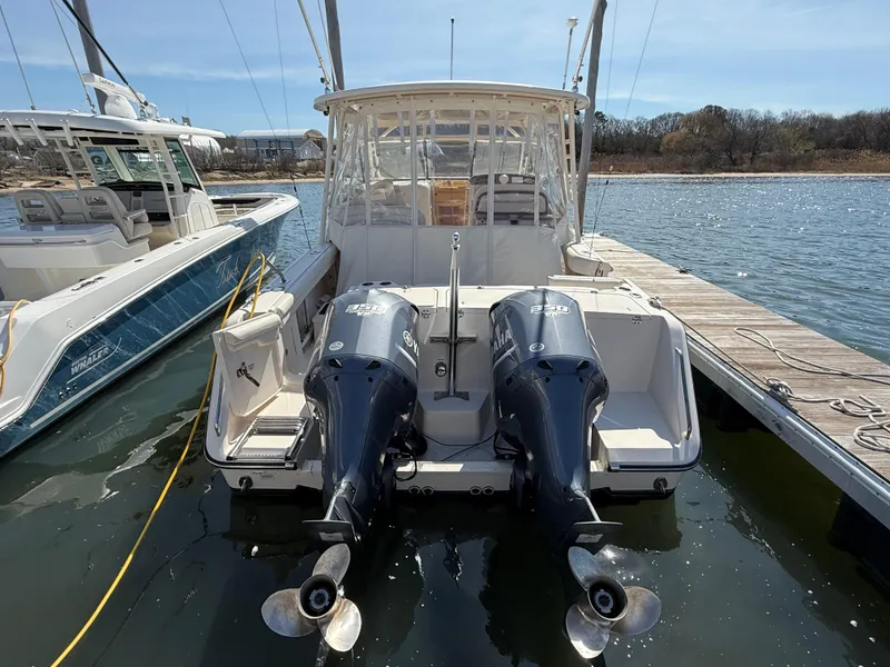 Slide: The Image of 2015 Grady-White Freedom 335 boat docked with dual outboard engines. - 5