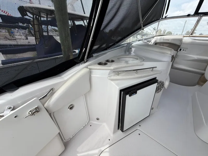 Slide: The Image of 2014 Glastron GS 289 boat interior with kitchenette and seating area. - 10