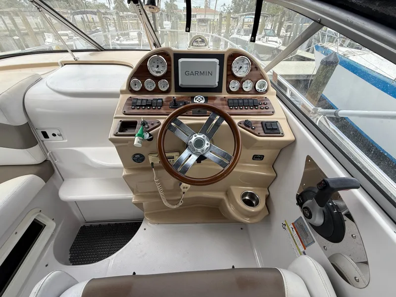 Slide: The Image of 2014 Glastron GS 289 boat dashboard with Garmin navigation system and steering wheel. - 21