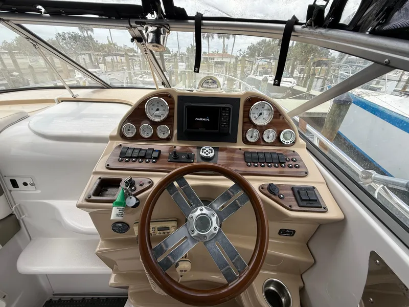 Slide: The Image of 2014 Glastron GS 289 boat dashboard with steering wheel and navigation instruments. - 22