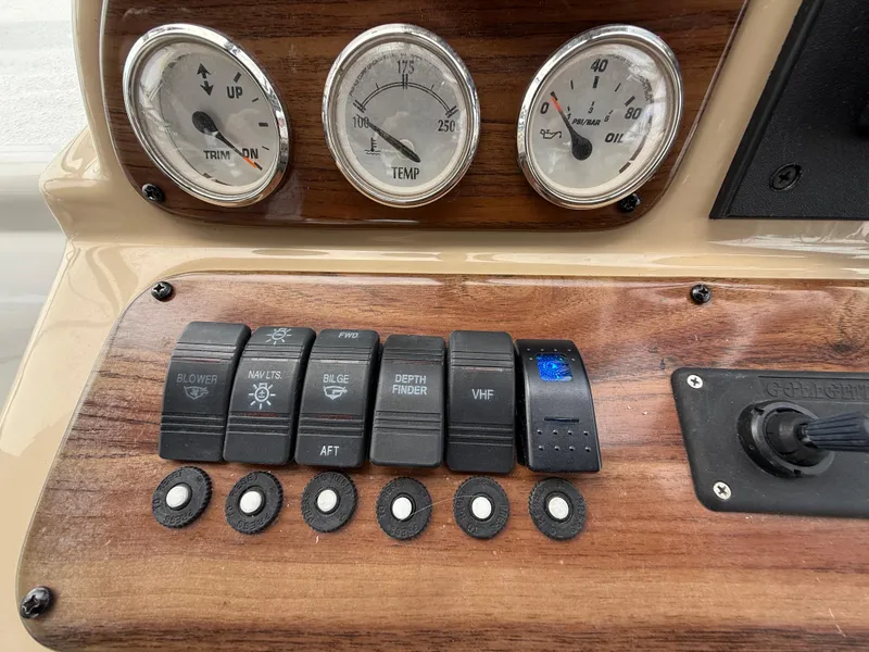 Slide: The Image of Control panel of 2014 Glastron GS 289 boat with switches and gauges. - 25