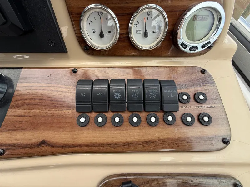 Slide: The Image of Control panel of 2014 Glastron GS 289 boat with switches and gauges. - 26
