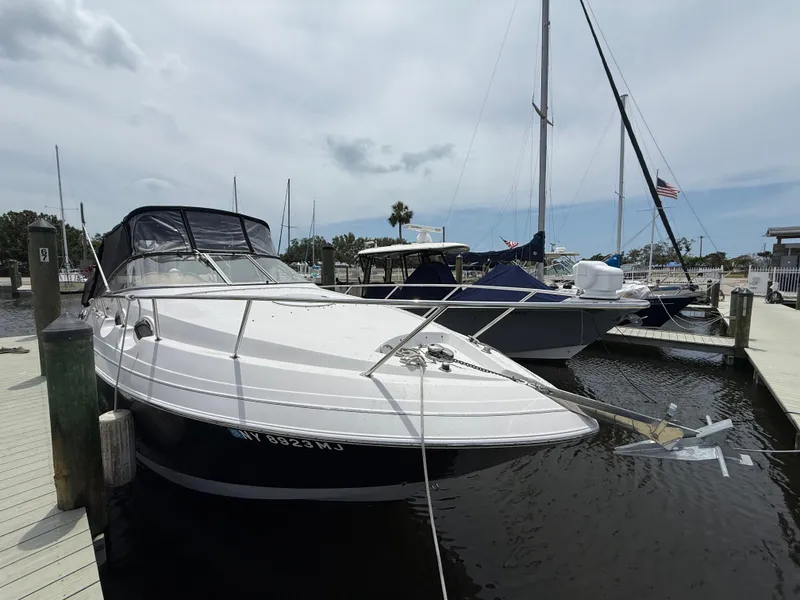 Slide: The Image of 2014 Glastron GS 289 boat docked at a marina under a cloudy sky. - 3