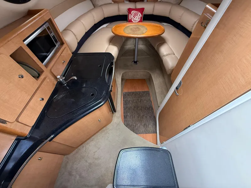 Slide: The Image of 2014 Glastron GS 289 cabin interior with kitchenette and seating area. - 30