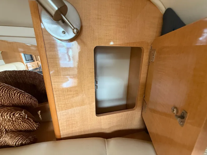 Slide: The Image of 2014 Glastron GS 289 interior with open wooden cabinet and modern light fixture. - 35