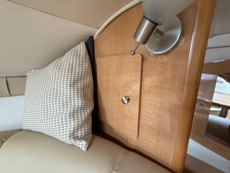 Slide: The Image of 2014 Glastron GS 289 cabin interior with wood paneling and cushion. - 36