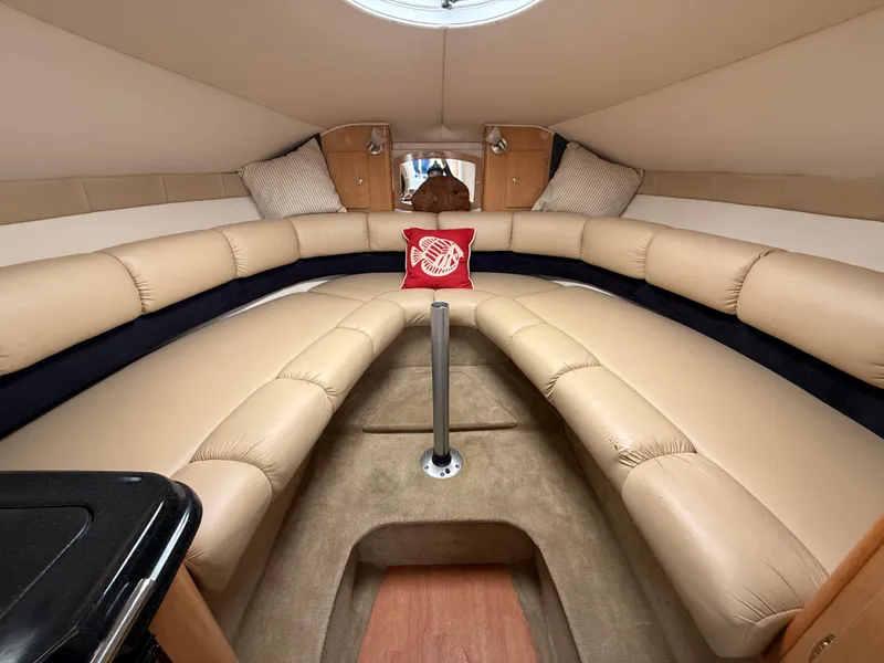 Slide: The Image of 2014 Glastron GS 289 cabin interior with beige seating and nautical decor. - 38