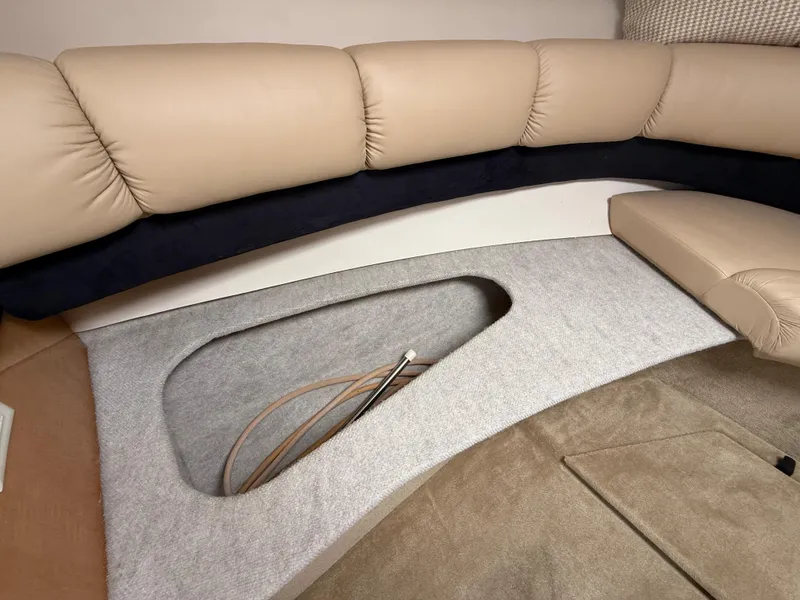 Slide: The Image of 2014 Glastron GS 289 interior with beige seating and storage compartment. - 39