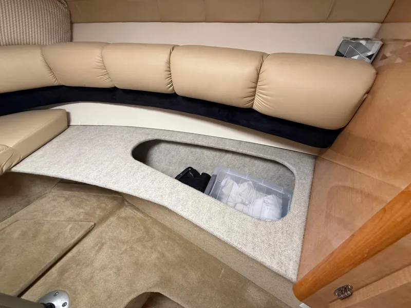 Slide: The Image of 2014 Glastron GS 289 interior with beige seating and under-seat storage compartment. - 40