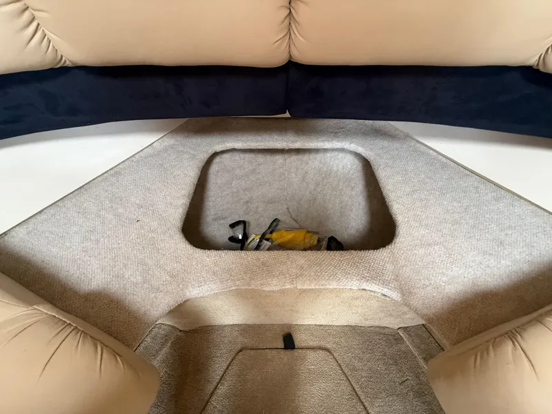 Slide: The Image of 2014 Glastron GS 289 boat interior storage compartment with beige and black seating. - 41