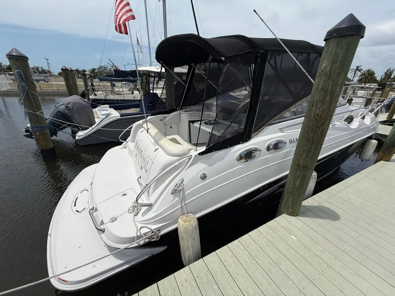 Slide: The Image of 2014 Glastron GS 289 boat docked at marina with American flag in background. - 5