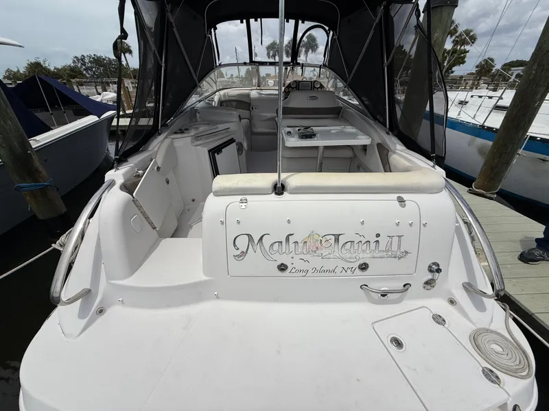 Slide: The Image of 2014 Glastron GS 289 boat docked, featuring spacious seating and sleek design. - 7