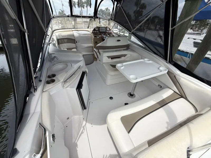 Slide: The Image of 2014 Glastron GS 289 boat interior with seating, table, and helm. - 9