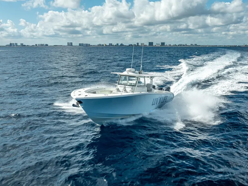 Slide: The Image of 2018 Yellowfin 42 boat cruising on open ocean under cloudy sky. - 10