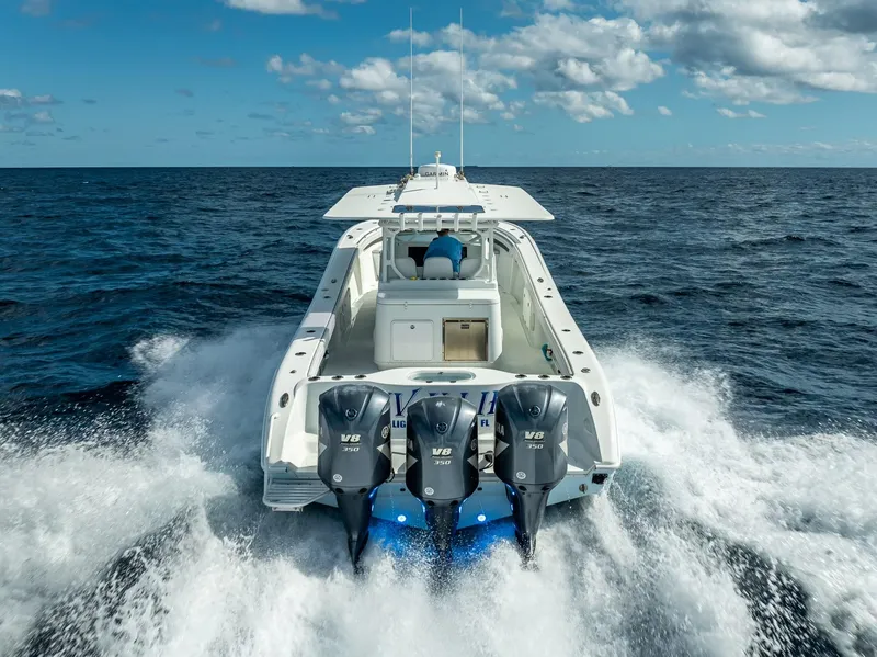 Slide: The Image of 2018 Yellowfin 42 boat with triple V8 engines cruising on open ocean. - 11