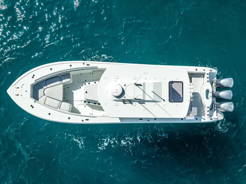 Slide: The Image of Overhead view of 2018 Yellowfin 42 boat on clear blue water. - 12