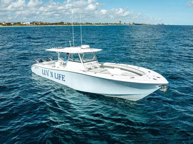 Slide: The Image of 2018 Yellowfin 42 boat named "LUV N LIFE" on open ocean under blue sky. - 15